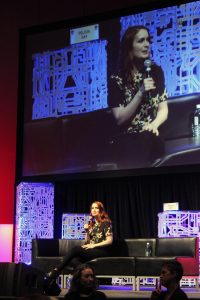 Felicia Day at Denver Comic Con 2017 with large screen in the background